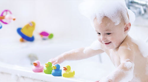 Ett barn leker i badkaret